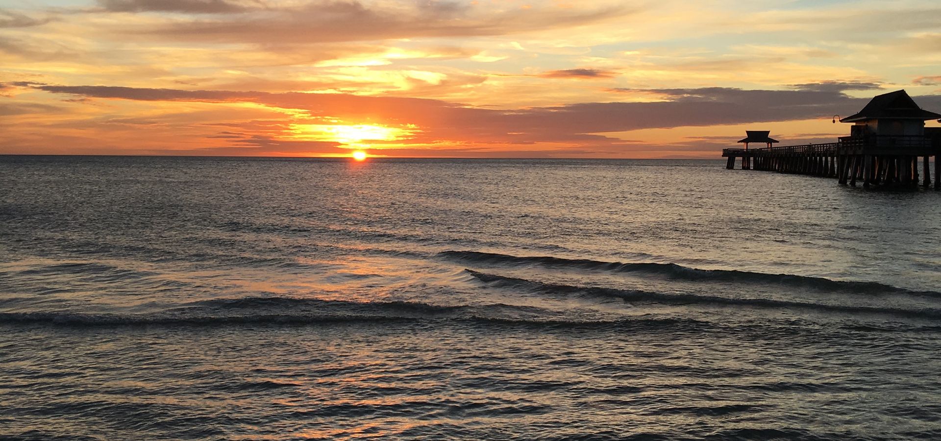 Sunset over the Gulf of Mexico at Naples Pier, Florida